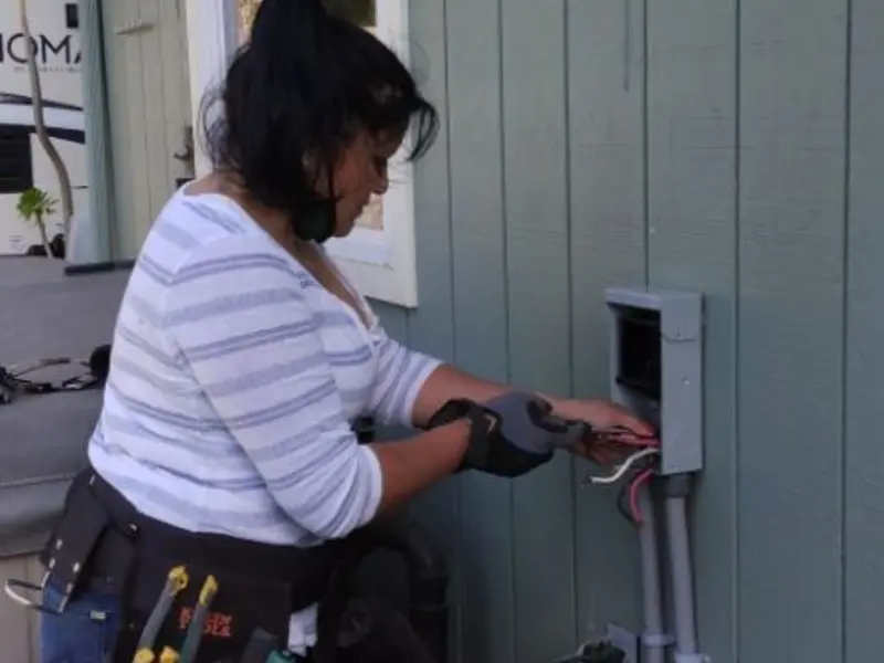 Licensed electrician wiring an exterior subpanel in Metuchen